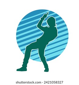 Silhouette of a female dancer in action pose. Silhouette of a slim woman in dancing pose.