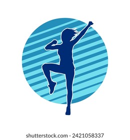 Silhouette of a female dancer in action pose. Silhouette of a slim woman in dancing pose.