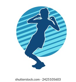 Silhouette of a female dancer in action pose. Silhouette of a slim woman in dancing pose.