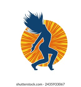 Silhouette of a female dancer in action pose. Silhouette of a slim woman in dancing pose.