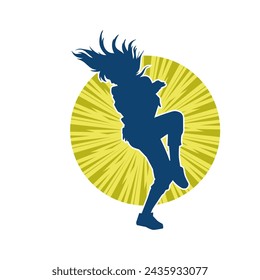 Silhouette of a female dancer in action pose. Silhouette of a slim woman in dancing pose.