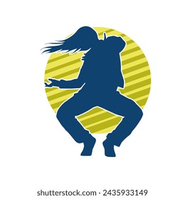 Silhouette of a female dancer in action pose. Silhouette of a slim woman in dancing pose.