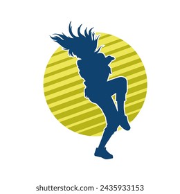 Silhouette of a female dancer in action pose. Silhouette of a slim woman in dancing pose.