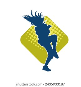 Silhouette of a female dancer in action pose. Silhouette of a slim woman in dancing pose.