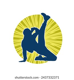 Silhouette of a female dancer in action pose. Silhouette of a slim woman in dancing pose.