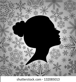 Silhouette of a female head against from snowflakes, vector