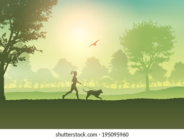 Silhouette of a female jogging with her dog in the countryside