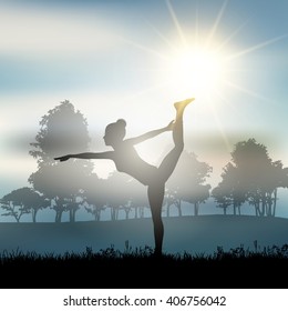 Silhouette of a female in a yoga pose in a sunny landscape