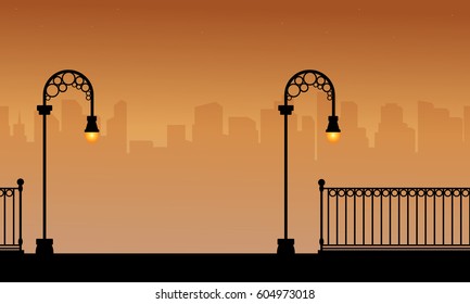 Silhouette of fence with street lamp landscape