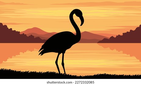 silhouette a flamingo standing by the lake at sunset