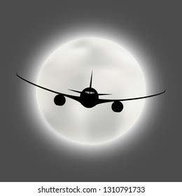 Silhouette of a flying plane on the background of a full bright moon disk