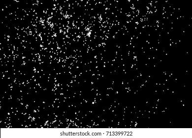 Silhouette of food flakes such as salt or almond or wheat flour spread on the flat surface or table. Abstract grainy texture isolated on black background. Top view of dust, sand blow or bread crumbs. 