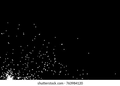 Silhouette of food flakes such as salt or almond or wheat flour spread on the flat surface or table. Abstract grainy texture isolated on black background. Top view of dust, sand blow or bread crumbs. 