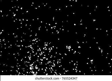 Silhouette of food flakes such as salt or almond or wheat flour spread on the flat surface or table. Abstract grainy texture isolated on black background. Top view of dust, sand blow or bread crumbs. 