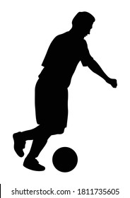 Silhouette of a football player who shooting a ball. 