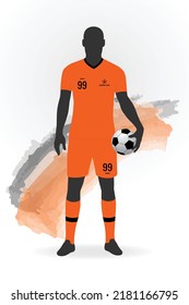 Silhouette of a football soccer player standing and holding a ball. Wearing Netherlands jersey kit.