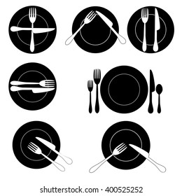 Silhouette of forks, spoons, table knives and plates.
