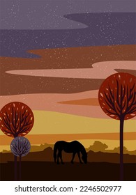 Silhouette of a free horse walking across the field against the backdrop of sunset and trees.