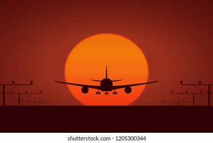 silhouette Front view of Passenger airplane landing on runway and big orange sunset sky background