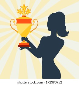 Silhouette of girl holding prize cup.