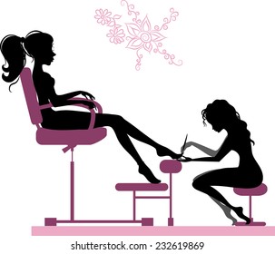 Silhouette of girl making pedicure in beauty salon