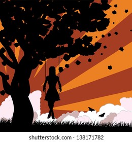 Silhouette of a girl on swing under the tree on sunset background.