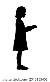 Silhouette of girl reading book while standing