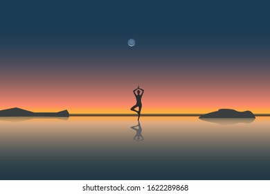 silhouette of a girl with a reflection on the sand, in a yoga stand on the beach or ocean on the background of a beautiful sunset. Theme of healthy lifestyle and relaxation.