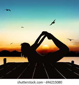 Silhouette girl yoga posture in the twilight.