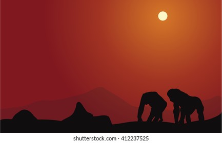 Silhouette of gorilla with mountain with orange backgrounds