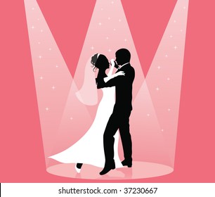 Silhouette of a groom and a bride dancing in the spot light.