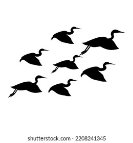 Silhouette of a group of storks flying together. Isolated on a white background. Vector illustration. Good for flying bird poster