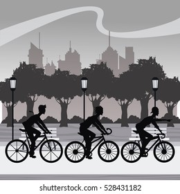 silhouette group younger riding bycicle park city background