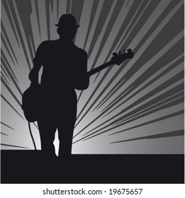 Silhouette of a guitar player on a stage
