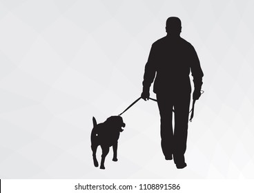 Silhouette of a guy with a dog. The guy goes for a walk with his dog.