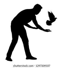 Silhouette of the guy lets go of the dove into the sky