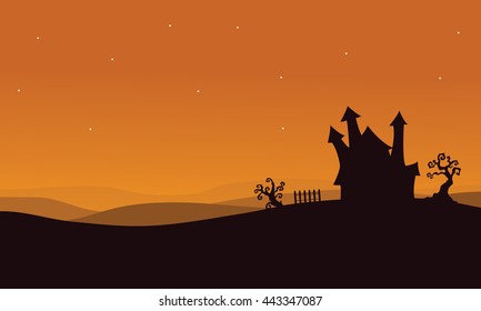 Silhouette of Halloween scary house with orange backgrounds