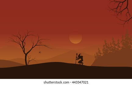 Silhouette of Halloween witch lonely with orange backgrounds