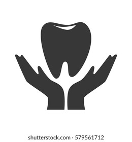 silhouette hand holding a tooth