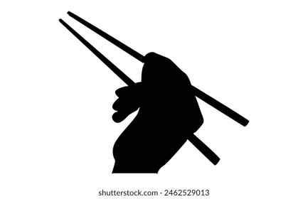 silhouette of hand holds chopsticks. Asian traditional cutlery