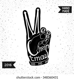 Silhouette of hands in the shape of V (victory), with the words Merry Christmas.
 Conceptual symbol for holiday greetings. Handmade vector design