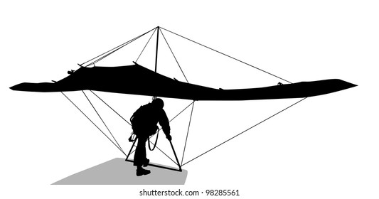 Silhouette of hang glider waiting to take off