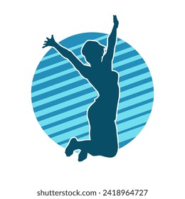 Silhouette of a happy slim woman jumping cheerfully.