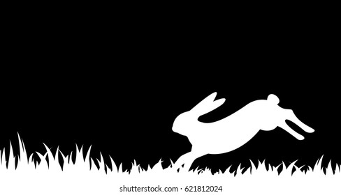 Silhouette of a hare in the grass.