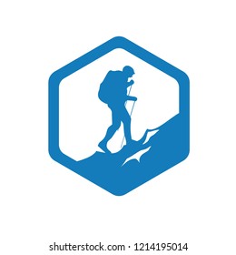 Silhouette of hiker climbs a mountain in a hexagon frame isolated on light background. Sign of nature lover, adventure, journey or travelers community logo or stamp