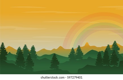 Silhouette of hill and spruce with beauty rainbow