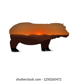 Silhouette of hippo with african landscape. Sunset. Dusk.
