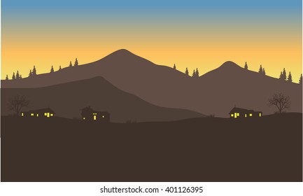 silhouette of the house below the mountain at night