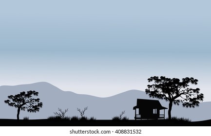 Silhouette of hut with trees and mountain backgrounds