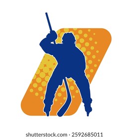 Silhouette of an ice hockey player wearing helmet and uniform carrying hockey stick in action pose